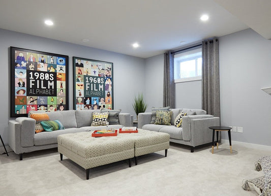 Basement family room with a sectional and short curtains on small high windows