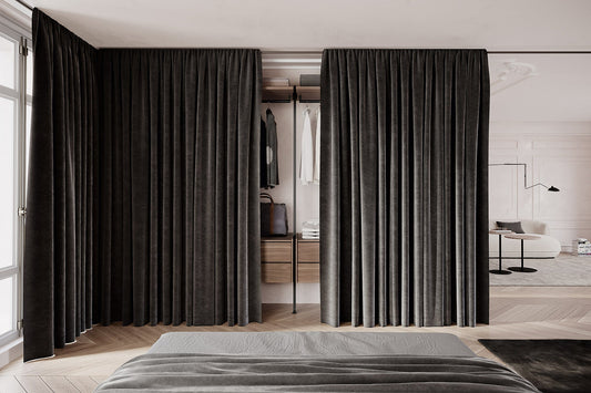 Bedroom with charcoal floor-length curtains used as a closet screen