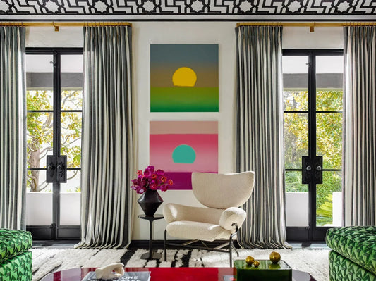 Living room with gray curtains on black-framed doors and bold abstract art