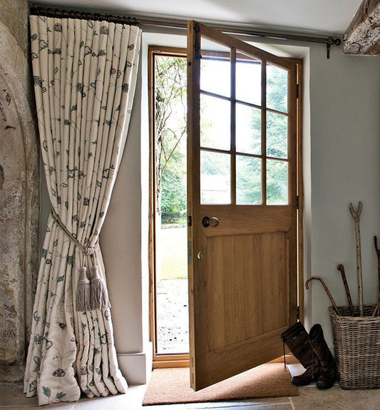 Open stable-style back door with a floral print curtain held back by a tie-back